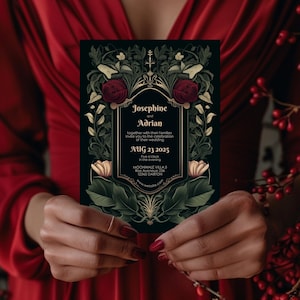 May include: A black wedding invitation with gold and red accents. The invitation features a floral design with red roses and green leaves. The text on the invitation reads "Josephine and Adrian" and includes the date "Aug 23 2025" and the time "Five o'clock in the evening".
