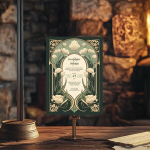 May include: A green and gold wedding invitation with an art nouveau design featuring white flowers. The invitation reads "Josephine & Adrian" and includes the date "August 23, 202X" and the time "5:00 PM". The location is listed as "Moonwale Villas & Gardens, 12345 Darton".