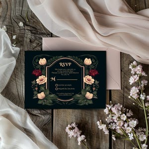 May include: A black RSVP card with a gold border and floral design. The text reads "RSVP" and "We hope you can join us on our special day! Please confirm your attendance by July 1st. M Joyfully accepts Regretfully Declines For online response visit www.websle.com"