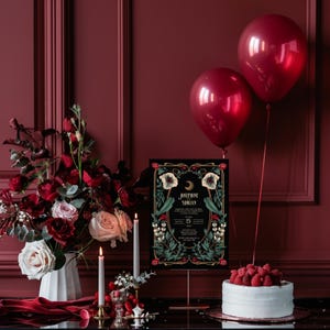 May include: A black and gold wedding invitation with floral designs and the text "Josephine & Adrian" on a black background. The invitation is displayed on a gold stand with two burgundy balloons in the background.