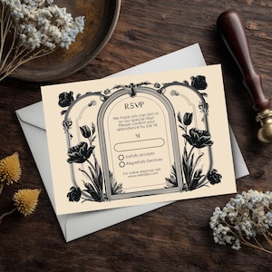 May include: An RSVP card with a floral design in black and cream. The card includes the text "RSVP" and prompts for attendance confirmation by July 1st. The design features decorative floral elements and a space for a name.