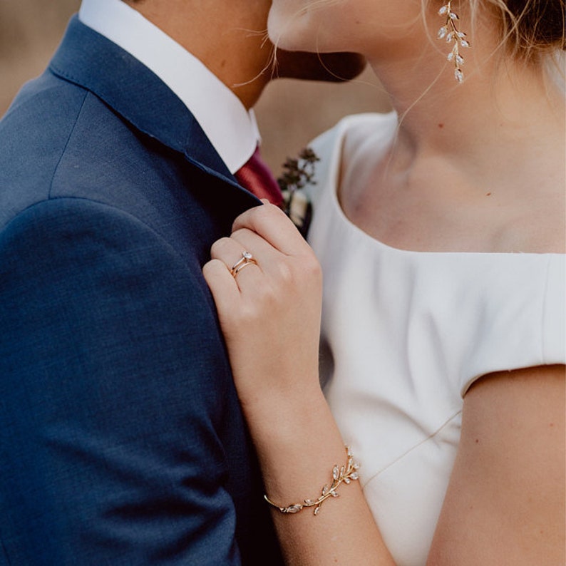 Rose gold cubic zirconia vine earrings and matching bracelet on bride