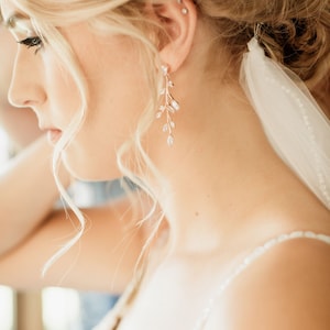 Long Rose gold vine earrings on bride