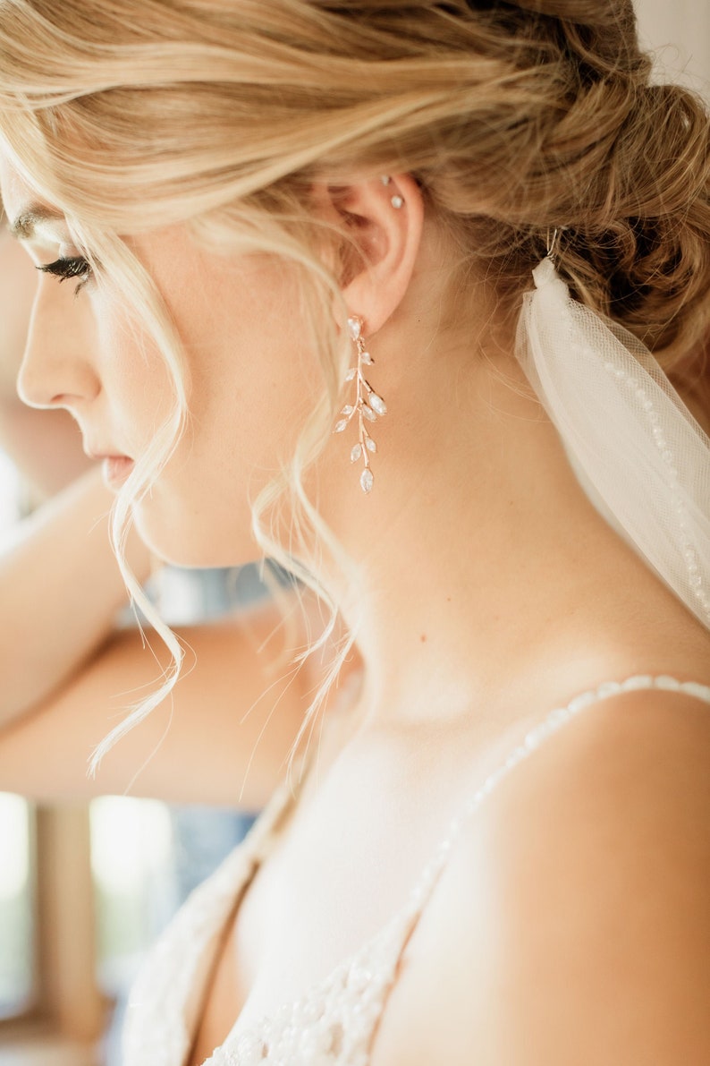 Long Rose gold vine earrings on bride