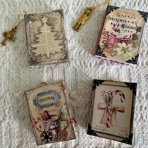 May include: Four rectangular ornaments featuring Christmas themes, including a tree on book pages, a mug with marshmallows, a mug with a reindeer, and a candy cane. Two gold-toned metal charms, one cross and one ornate key, are included with the set.