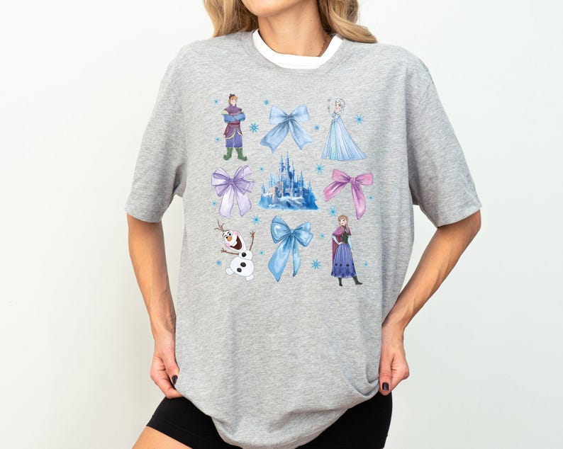 a woman wearing a gray shirt with disney characters on it