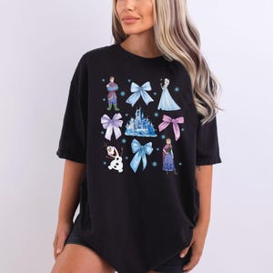 a woman wearing a black tshirt with disney characters on it