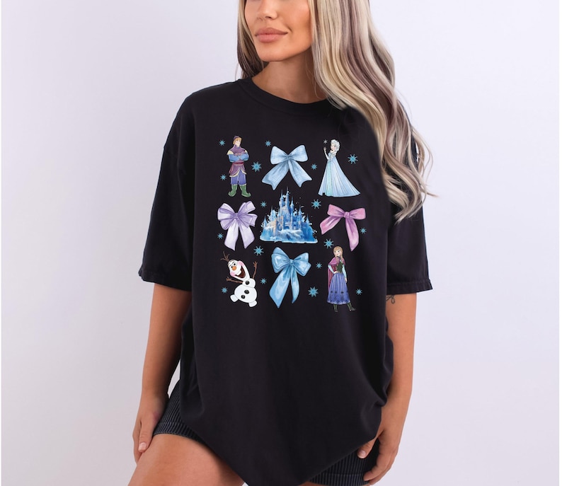 a woman wearing a black tshirt with disney characters on it