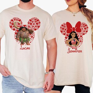 a man and a woman wearing mickey mouse shirts