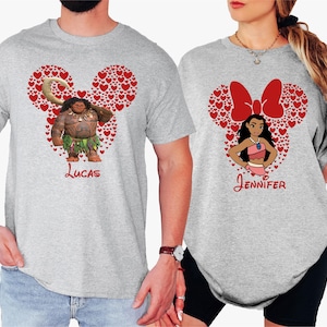 a man and woman wearing mickey mouse shirts