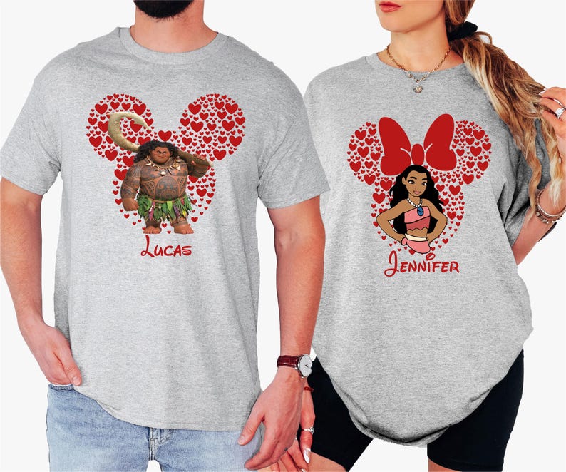 a man and woman wearing mickey mouse shirts