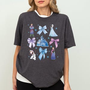 a woman wearing a disney tshirt with princesses on it