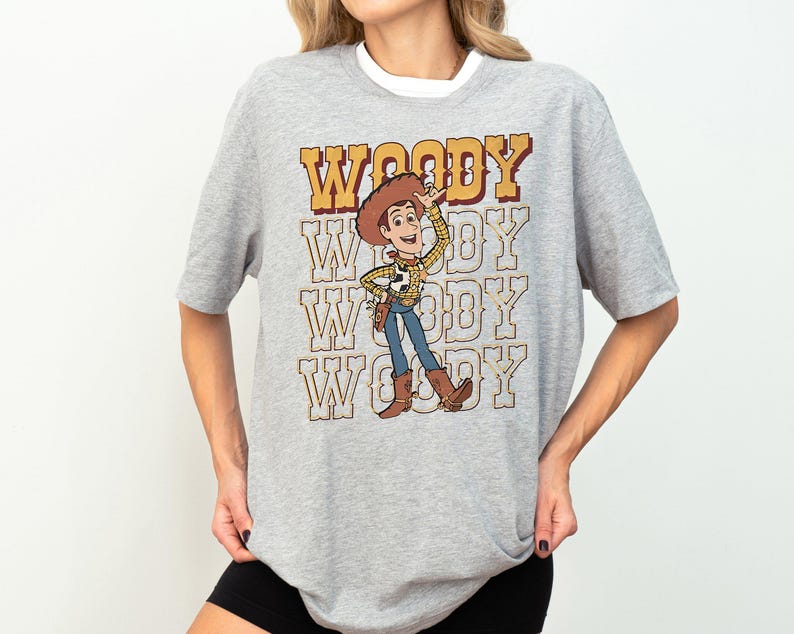 a woman wearing a woody t - shirt and shorts