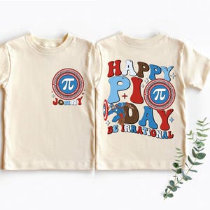 Könnte beinhalten: Ein Set aus drei Keramikbechern mit gesprenkelter, matter Oberfläche. Die Becher sind in Creme-, Hellgrau- und Dunkelgrautönen gehalten. Jeder Becher hat ein schlichtes, minimalistisches Design und einen abgerundeten Henkel. Die Becher sind aufeinander gestapelt.