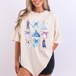 a woman wearing a white shirt with disney characters on it