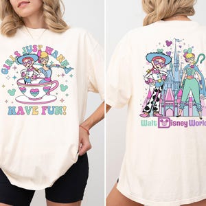 a woman wearing a white shirt with a cartoon character on it