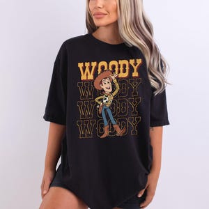 a woman wearing a black woody t - shirt