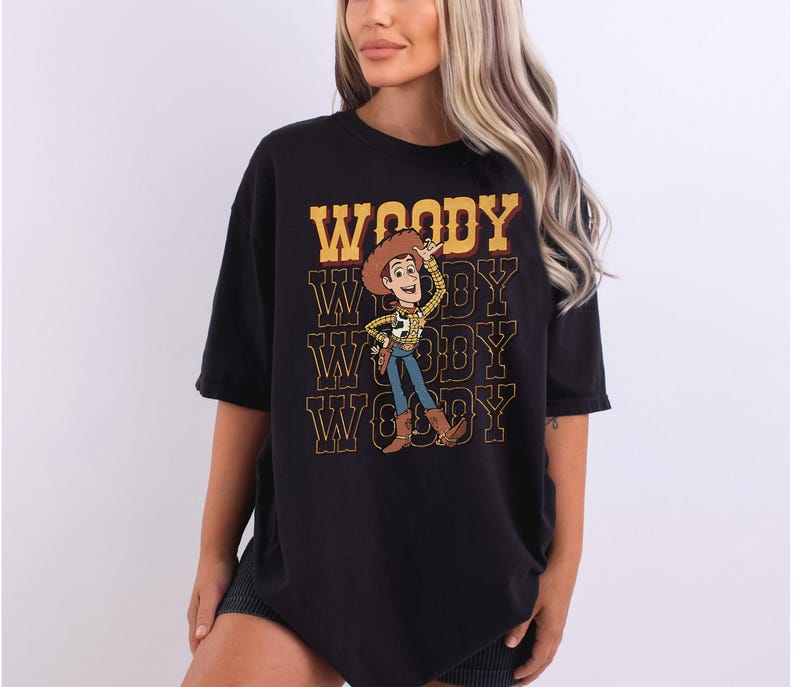 a woman wearing a black woody t - shirt