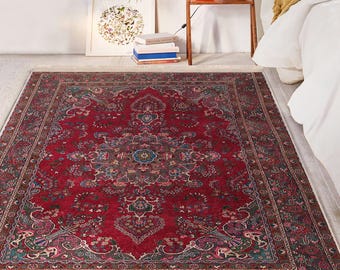May include: A red, blue, and green patterned rug with a floral design. The rug has a border with a repeating pattern.
