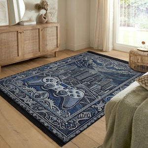 Puede incluir: Una alfombra azul y negra con un diseño estilizado de un mando de videojuego. La alfombra tiene un borde detallado con un patrón floral.