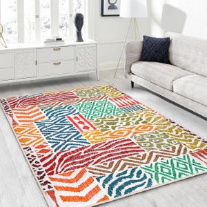 May include: Multicolored area rug with a geometric pattern featuring various shapes and colors, including red, orange, yellow, green, blue, and white.