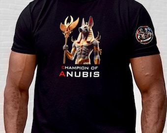 May include: Black t-shirt with a graphic of Anubis, an Egyptian god, holding a staff. The text "Champion of Anubis" is printed below the image.