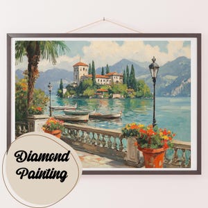 May include: A painting of a lake scene with a castle on an island in the distance. The lake is blue and the sky is light blue. There are trees and flowers in the foreground. The painting is framed in a dark brown frame.