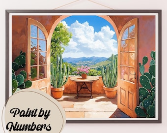 May include: A painting of a patio with a view of a mountain range. The patio has two open doors, a table with a vase of flowers, and two cactus plants in pots. The painting is framed and has the words "Paint by Numbers" in the lower left corner.