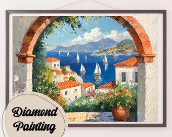 May include: A diamond painting of a picturesque Mediterranean scene.  The painting depicts a white archway with a view of a blue ocean with sailboats and a small town with white buildings and orange roofs.  The painting is framed in a dark brown frame.