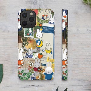 a phone case with a sticker on it next to a flower