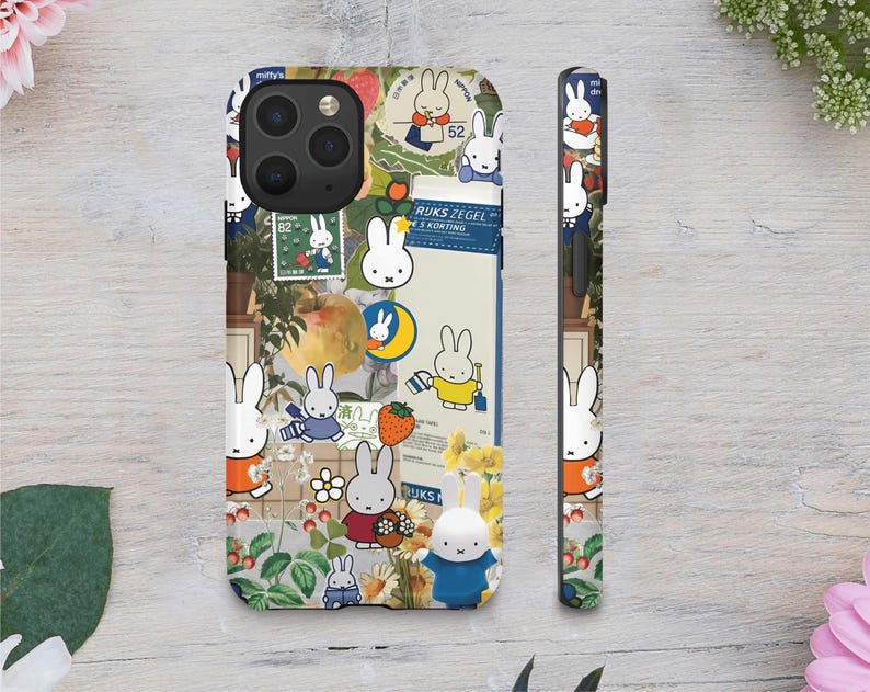 a phone case with a sticker on it next to a flower