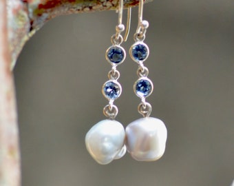 White pearl blue topaz earrings.  Sterling  silver earrings. Free form fresh water pearl earrings. Silversmith fine jewelry.