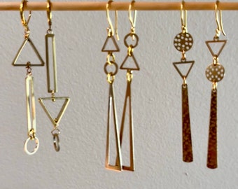 Asymmetrical geometric brass earrings.  Mismatched long abstract earrings. Hammered statement modern gold tone earrings. Jewelry trend.