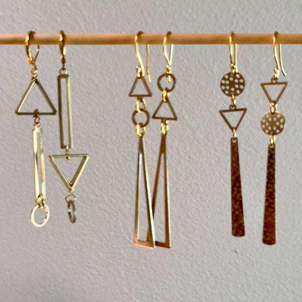 Asymmetrical geometric brass earrings.  Mismatched long abstract earrings. Hammered statement modern gold tone earrings. Jewelry trend.