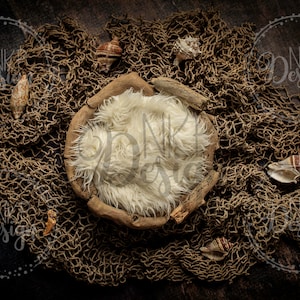 May include: A rustic wooden bowl filled with a white faux fur insert, surrounded by a brown fishing net with seashells scattered throughout.