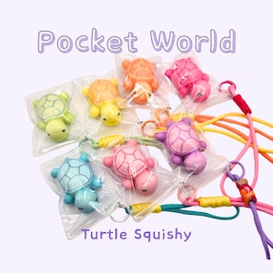May include: A collection of colorful turtle-shaped squishy toys in clear plastic packaging. The turtles come in various colors, including green, orange, pink, and blue, and are attached to keychains with colorful cords. The text "Pocket World" and "Turtle Squishy" are visible.