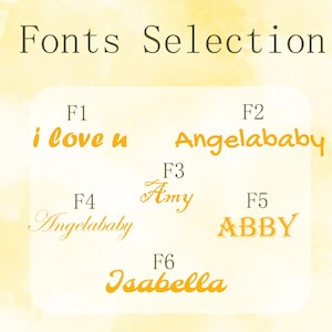 May include: An image displaying font choices. The title "Fonts Selection" is at the top. Six font styles are shown, each with a name and a sample phrase in a golden-yellow hue. The phrases include "i love u", "Angelababy", "Amy", "ABBY", and "Isabella".