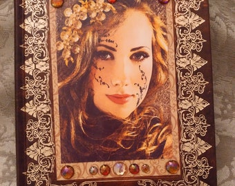 Gorgeous journal in deep brown faux leather look with shiny gold stylized leaf design framing portrait of beautiful blond woman