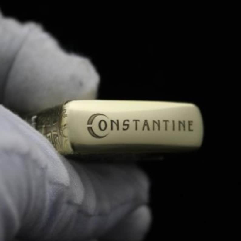 May include: A gold lighter with the word "CONSTANTINE" engraved on the side.