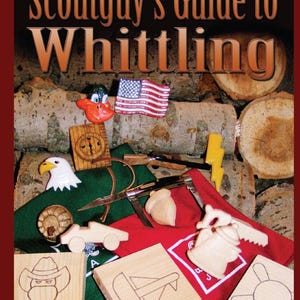 May include: A book titled "Scoutguy's Guide to Whittling" by John Hackett. The cover features a red, white, and blue American flag, a wooden compass, a carved wooden eagle, a wooden acorn, a wooden teapot, and a wooden sailboat.