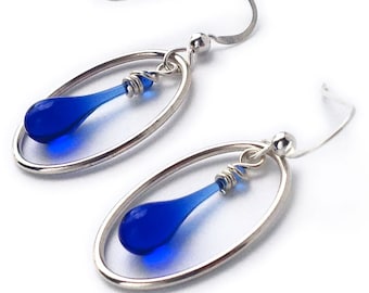 Oval-framed drop earrings, featuring sun-melted recycled glass and recycled sterling silver