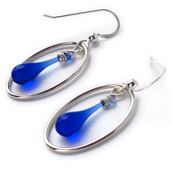 Oval-framed drop earrings, featuring sun-melted recycled glass and recycled sterling silver