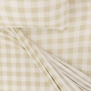 May include: A beige and white checkered bed sheet with a beige pillowcase on top. The sheet is folded and the pillowcase is lying flat.