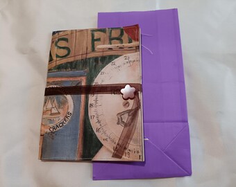 Wallpaper covered Junk Journal with goodie bad.