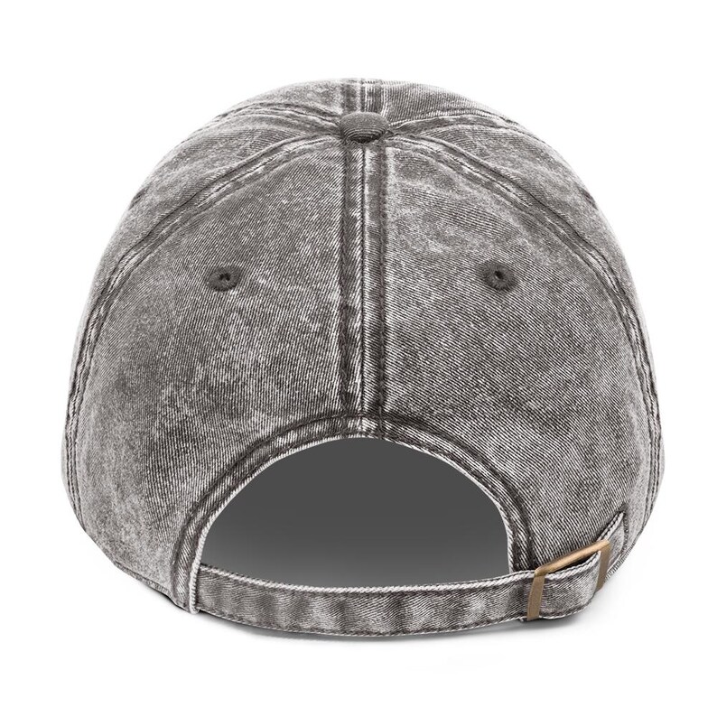 May include: A grey, distressed baseball cap with a curved peak. The back of the cap has an adjustable strap with a metal buckle. The cap has a worn, vintage appearance.