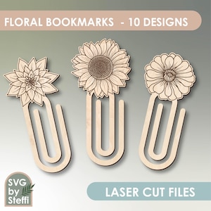 May include: Three laser cut bookmark designs featuring floral motifs. The bookmarks are made of wood and have a simple, elegant design. The designs include a sunflower, a dahlia, and a zinnia.