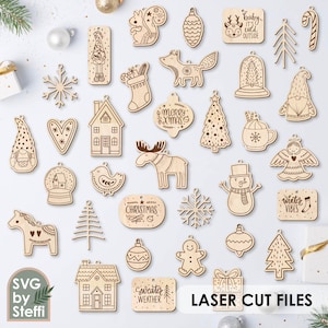 Könnte beinhalten: Eine Sammlung lasergeschnittener Weihnachtsornamente aus Holz in verschiedenen Formen, darunter ein Eichhörnchen, ein Fuchs, ein Haus und ein Schneemann. Einige Ornamente tragen Texte wie "Merry Xmas" und "Winter Vibes". Der Satz "LASER CUT FILES" ist ebenfalls sichtbar.