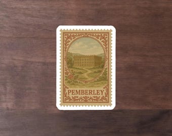 May include: A rectangular sticker with a vintage stamp design. The stamp features a detailed illustration of a stately building, a winding path, and the word "PEMBERLEY" in a serif font. The border is a cream color with a decorative floral design.