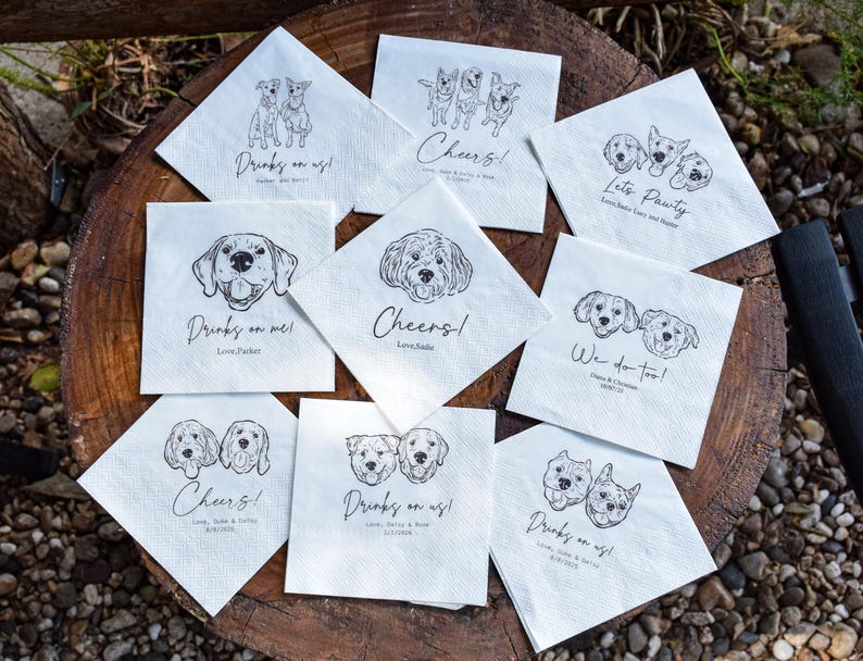 May include: A collection of white square napkins with black line drawings of dogs. Each napkin features a different dog breed or pair of dogs, along with phrases like "Drinks on us!" and "Cheers!" Ideal for a dog-themed party or event.