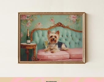 May include: A framed print featuring a Yorkshire Terrier on a pink sofa with a glass of champagne. The dog is the focal point, set against a backdrop of a teal sofa and floral wallpaper. A champagne bottle sits on a side table.